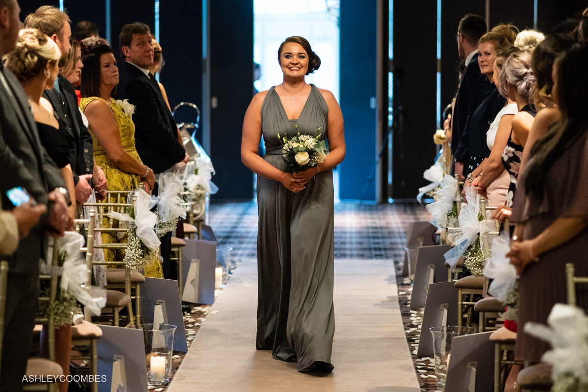 Bridesmaid comes down aisle