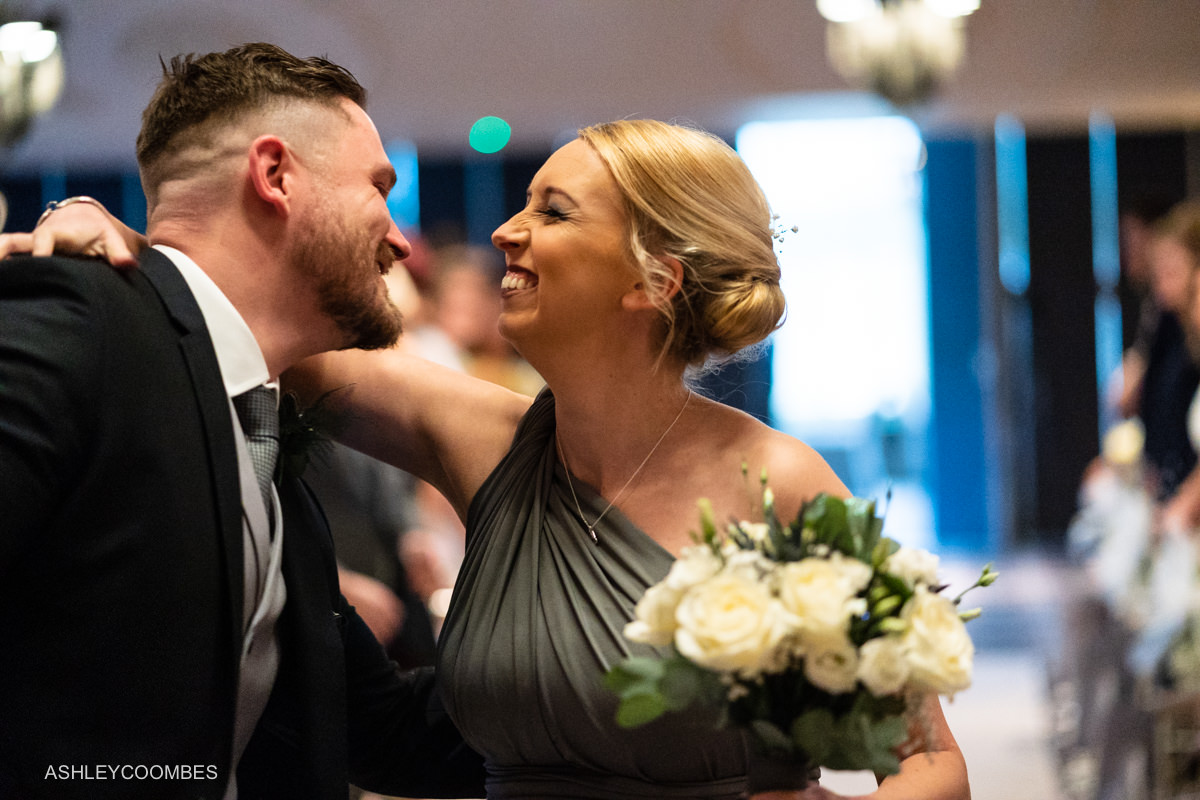 bridesmaid kisses groom