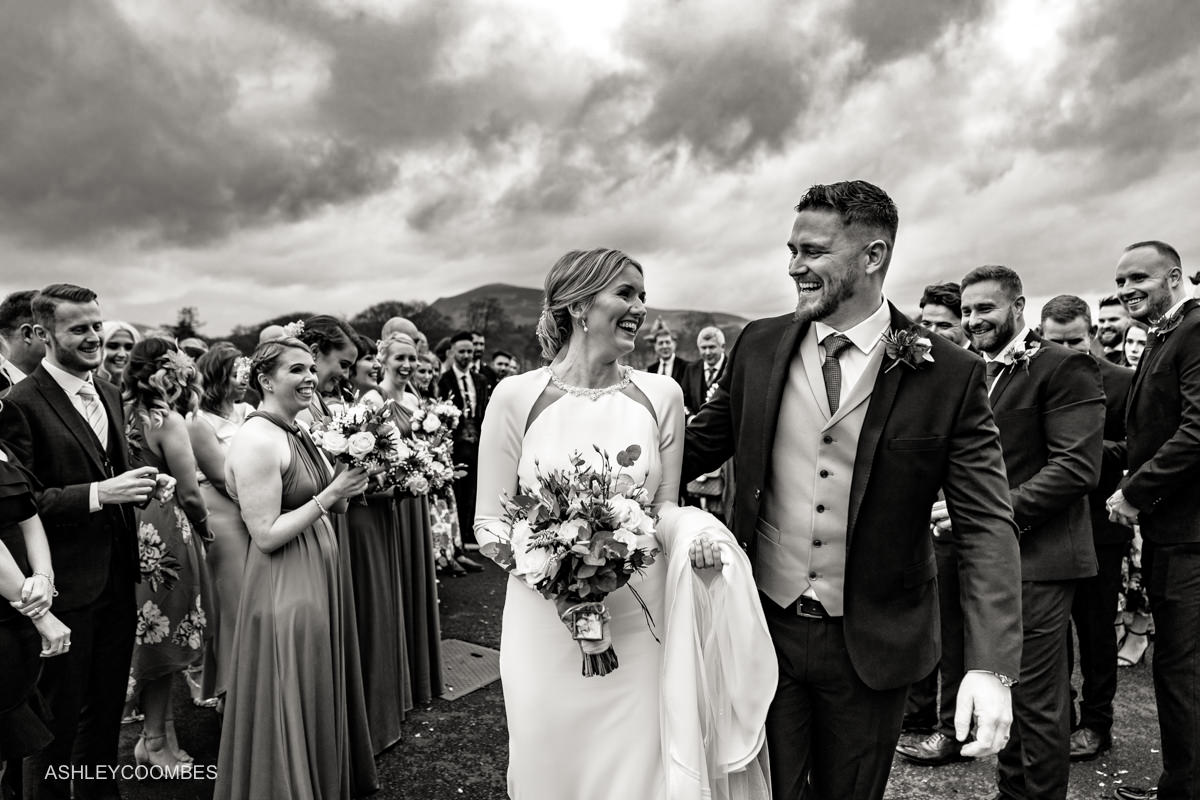 bride and groom with cloudy sky