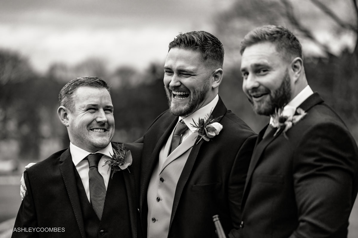 groom laughing with groomsmen